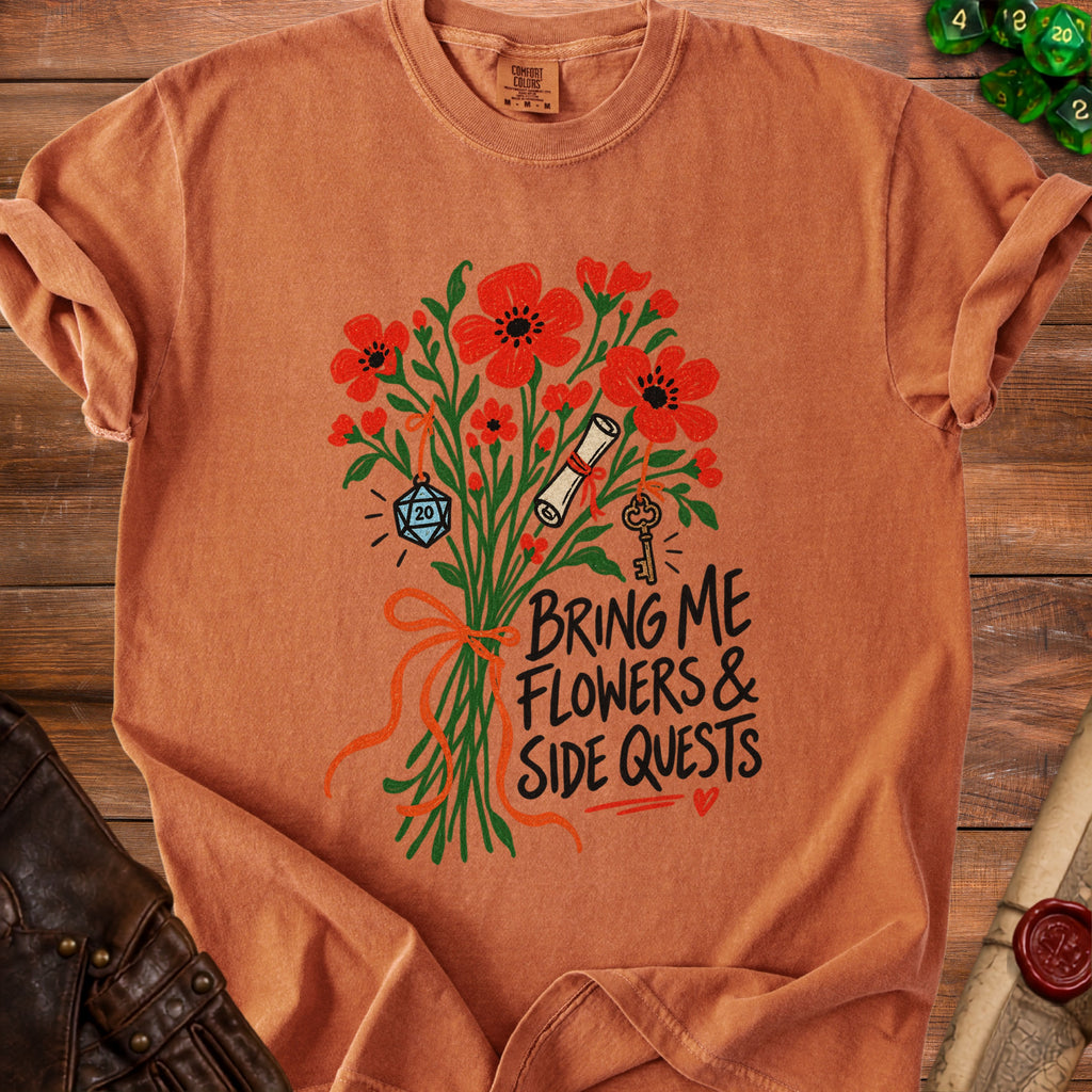 Orange t-shirt with flowers, scroll, key, and D20 dice. "Bring Me Flowers & Side Quests."