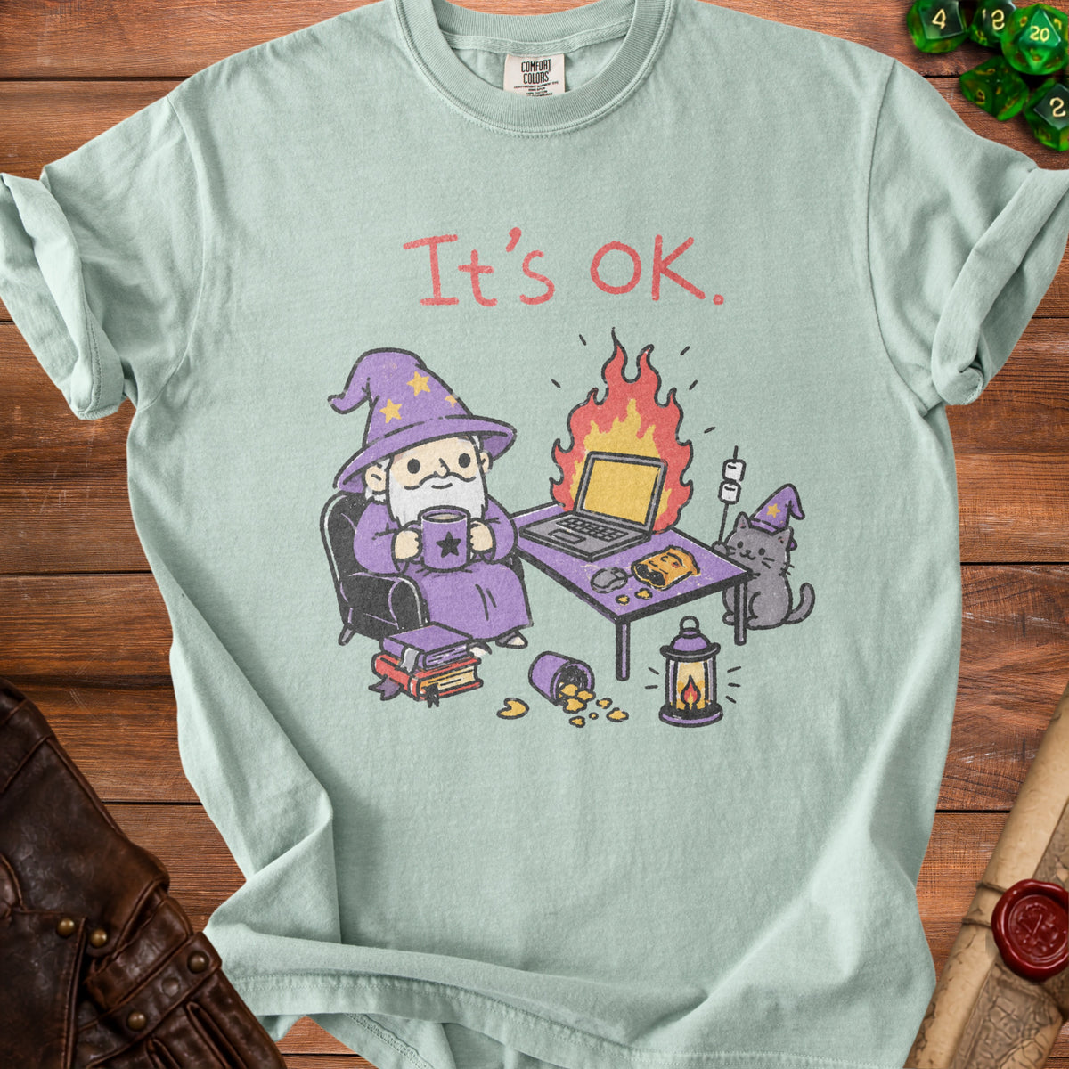 Light green t-shirt with wizard, cat, burning laptop, and "It's OK." text.
