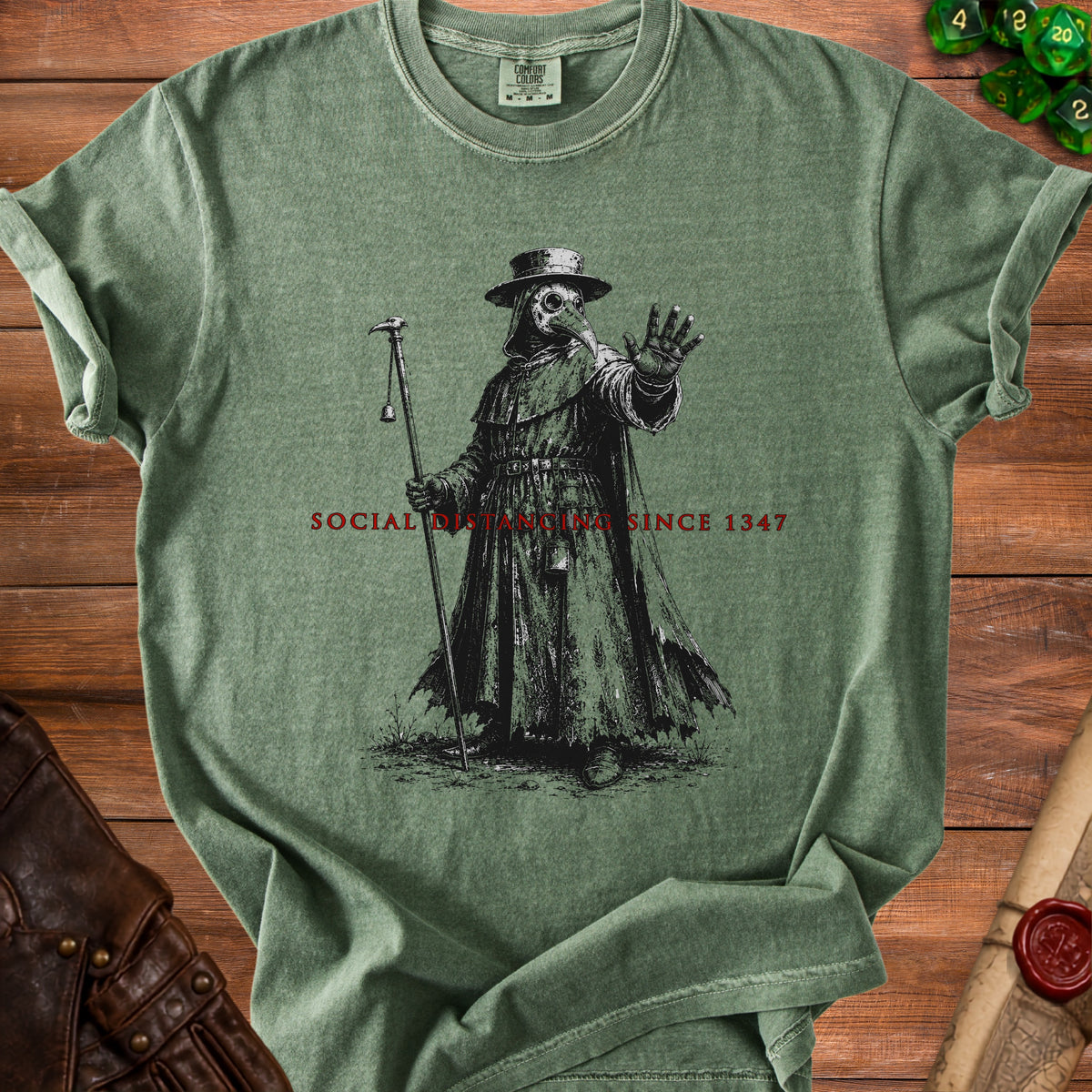 Green t-shirt with plague doctor graphic and "Social Distancing Since 1347".