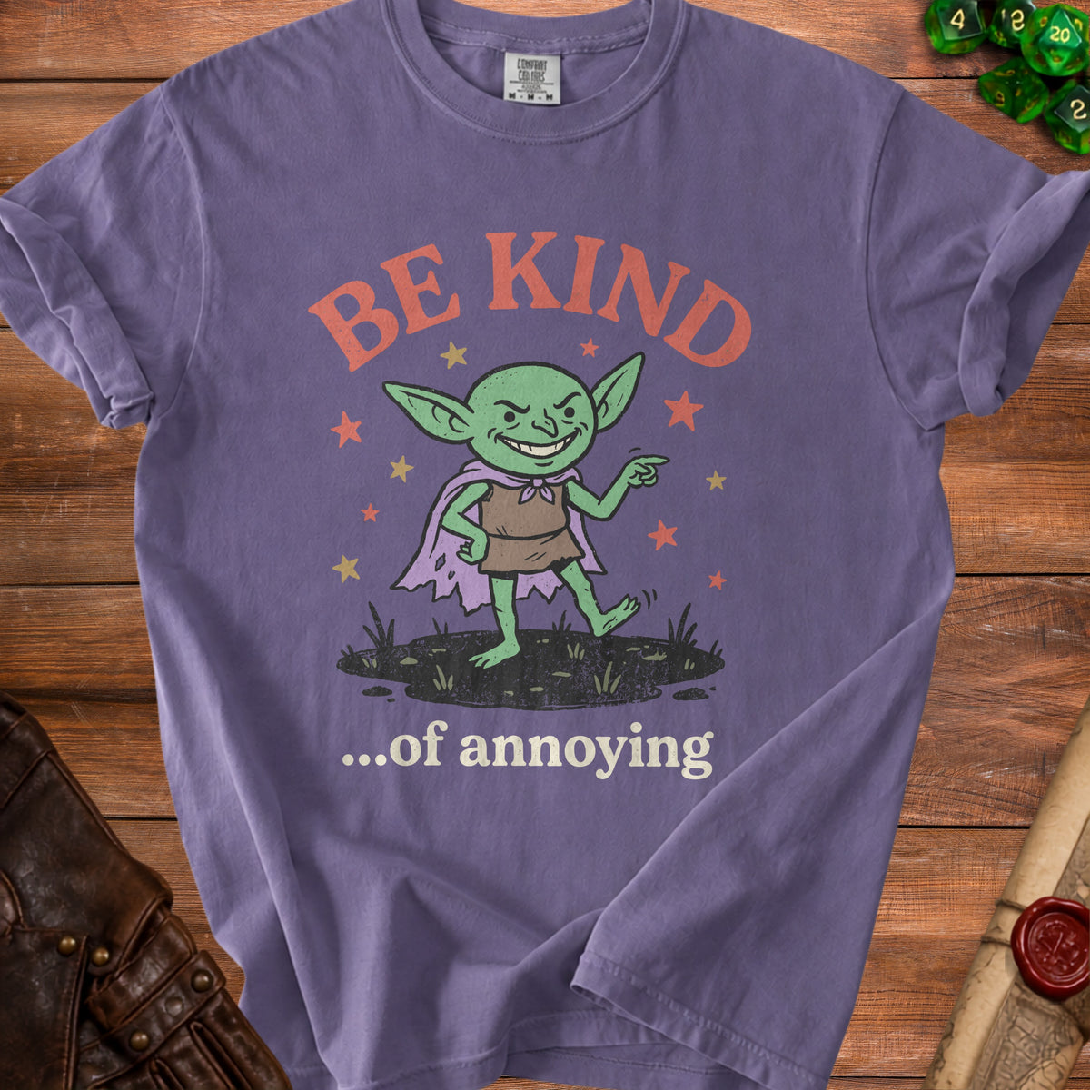 Purple t-shirt with a cartoon goblin graphic saying "BE KIND ...of annoying."