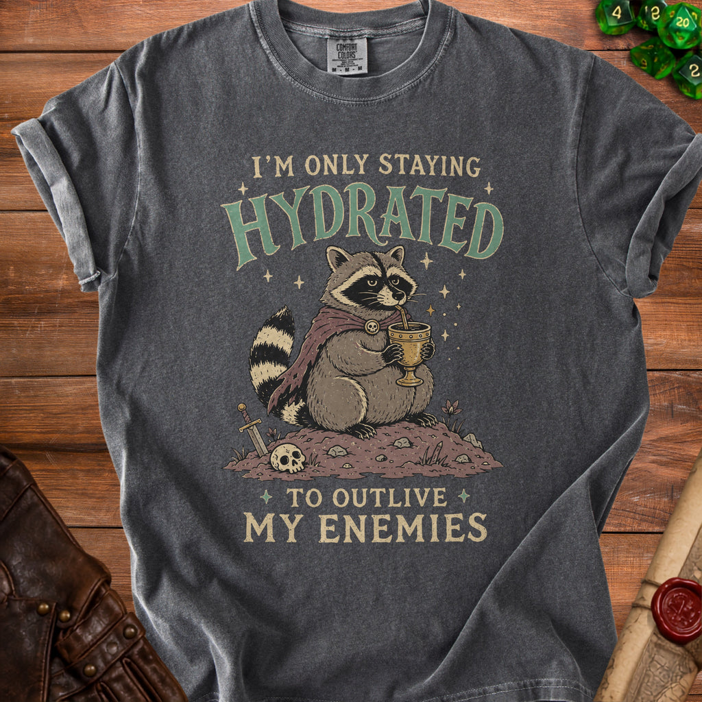 T-shirt with raccoon drinking from chalice, "I'm only staying hydrated to outlive my enemies."