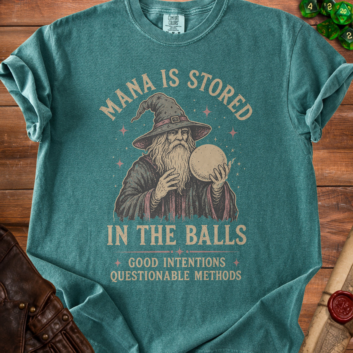 T-shirt with wizard graphic and text "Mana is stored in the balls. Good intentions questionable methods."