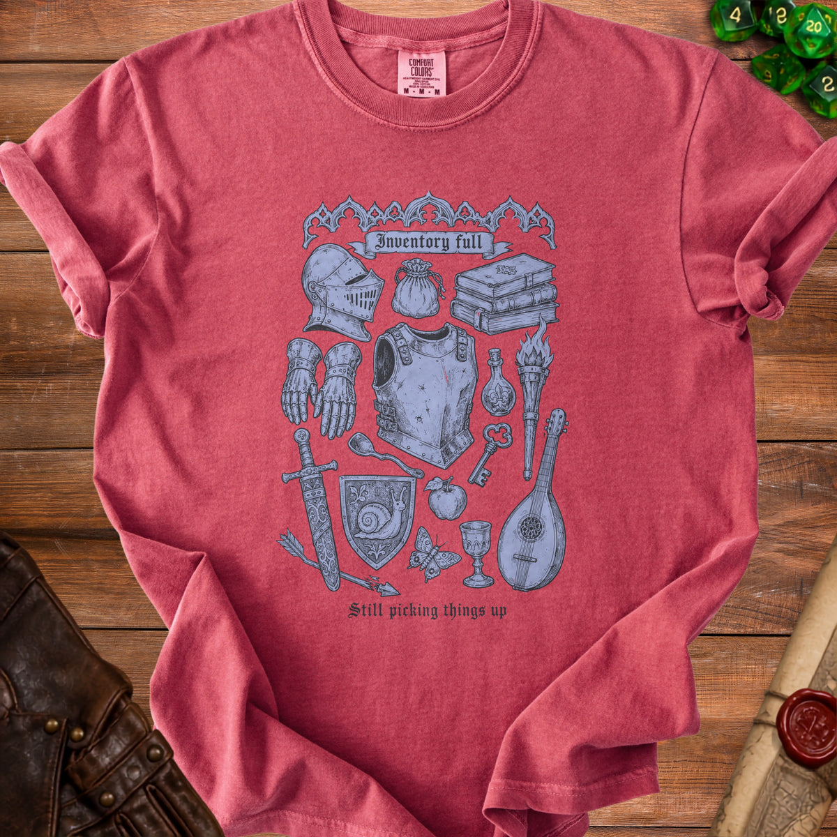 T-shirt with medieval fantasy illustration and text "Inventory full" and "Still picking things up".