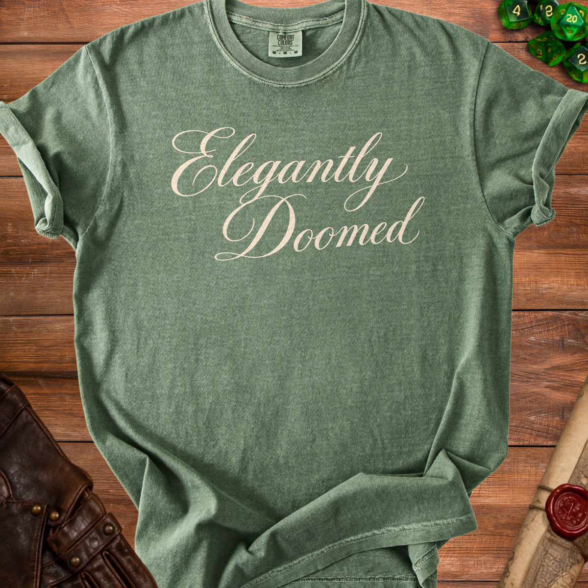 Green t-shirt with "Elegantly Doomed" text and a Comfort Colors tag.