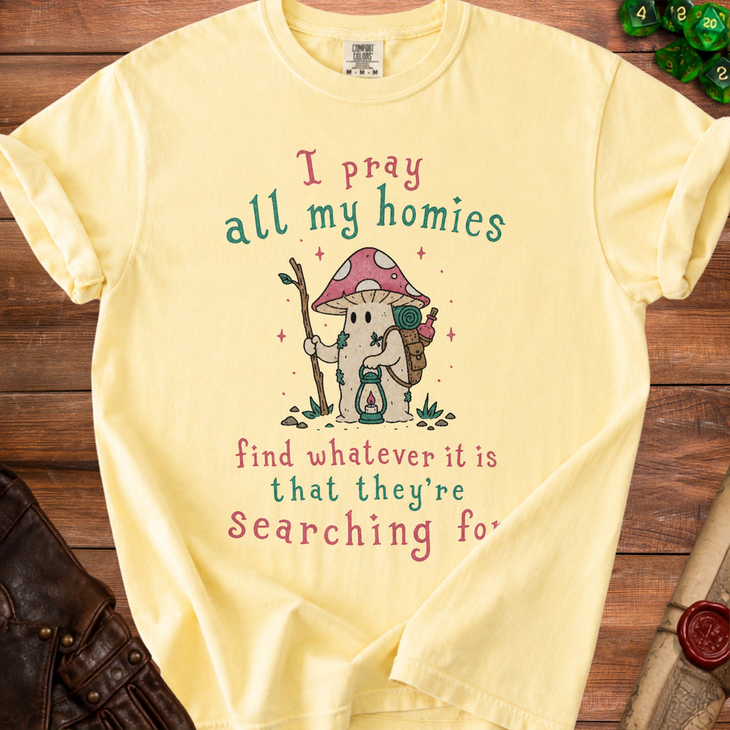 Yellow t-shirt with mushroom character and text "I pray all my homies find whatever it is that they're searching for".