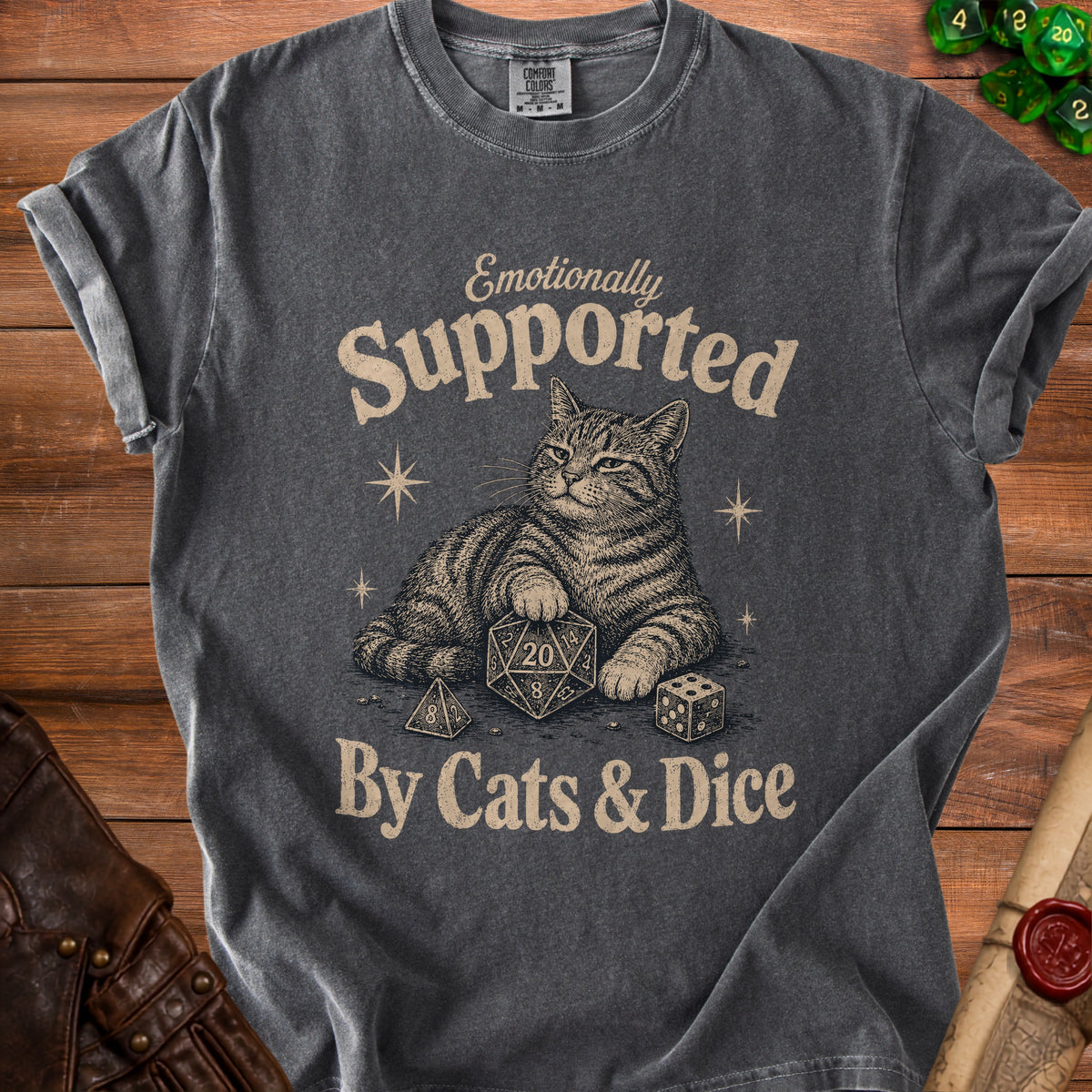 T-shirt with a cat lying down with dice, reading "Emotionally Supported By Cats & Dice."