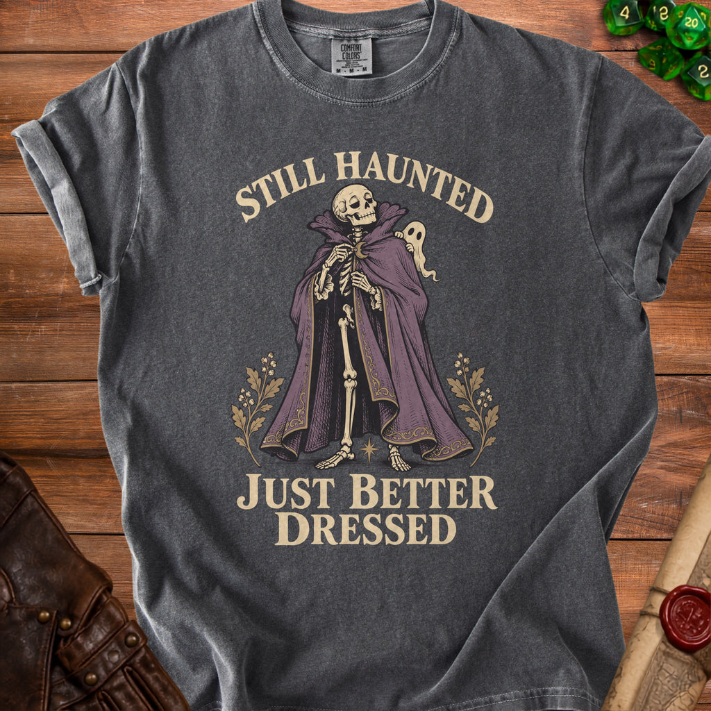 Dark grey t-shirt with skeleton, ghost, and text "Still Haunted Just Better Dressed".