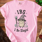 Pink t-shirt with cartoon scroll wearing wizard hat and holding staff, text "IBS I Be Slayin'".