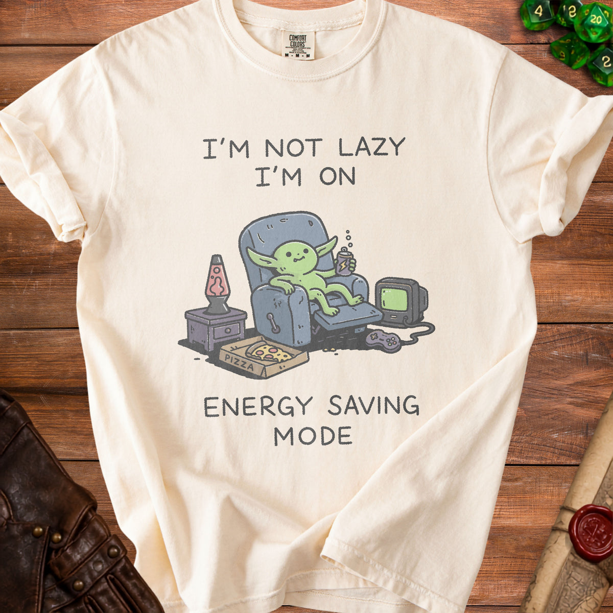 Cream t-shirt with graphic of a goblin saying "I'm not lazy I'm on energy saving mode."