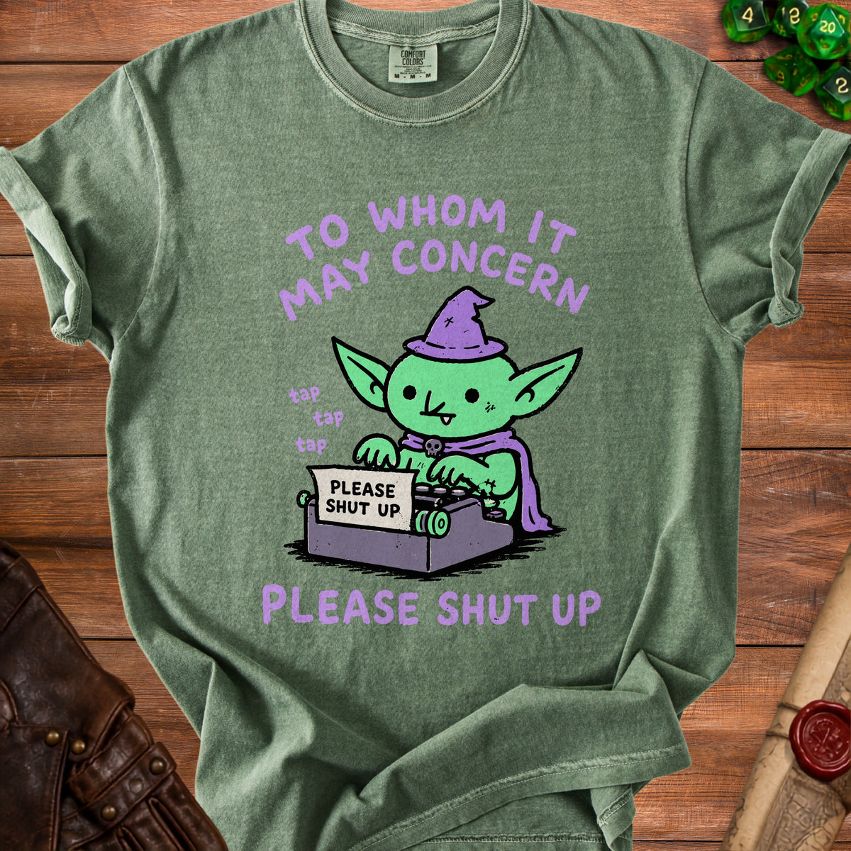 Green t-shirt with cartoon goblin wearing a witch hat and typing on a typewriter.