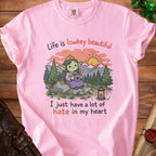 Pink t-shirt with a cartoon goblin and text: "Life is lowkey beautiful, I just have a lot of hate in my heart."