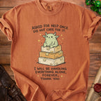 Orange t-shirt with cartoon monster on boxes and text about handling things alone.