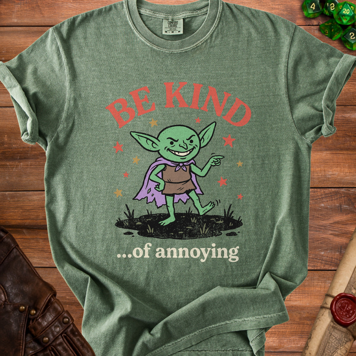 Green t-shirt with a goblin character and text "BE KIND ...of annoying."