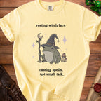Yellow t-shirt with a frog casting spells and text "resting witch face, casting spells, not small talk".