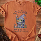 T-shirt with frog wizard graphic and text "I don't know what lies ahead... but I do know it will be an adventure"