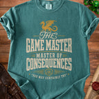 Green t-shirt with gold dragon and text: "The Game Master Master of Consequences".