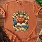 Orange t-shirt with "Lore Management: It Was In My Notes" graphic featuring dice and books.