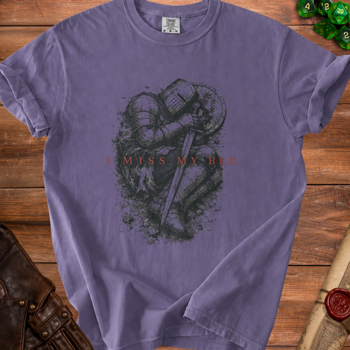 Purple t-shirt with knight graphic and text "I MISS MY BED"