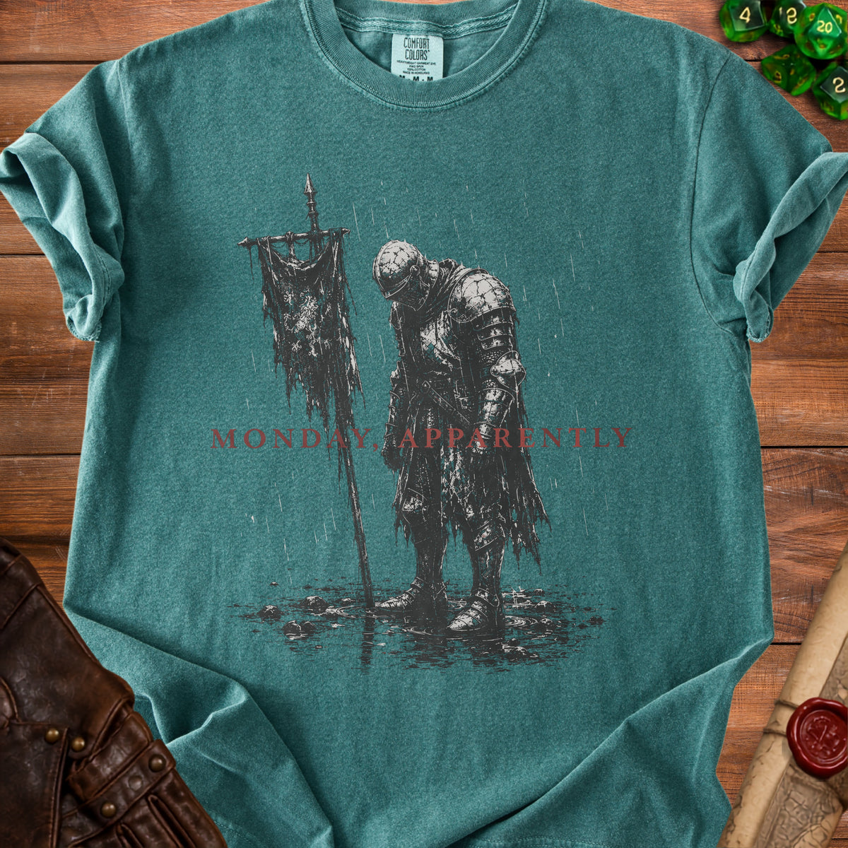 T-shirt with a knight holding a tattered banner, "MONDAY APPARENTLY" text.