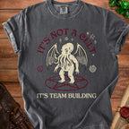 Dark gray t-shirt with Cthulhu graphic and text "It's Not a Cult. It's Team Building."