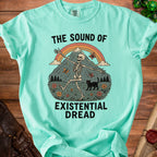 T-shirt with skeleton, black cat, rainbow, mountain, and text "The Sound of Existential Dread".
