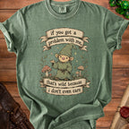 Green t-shirt with a cartoon gnome graphic and text "if you got a problem with me, that's wild because i don't even care".