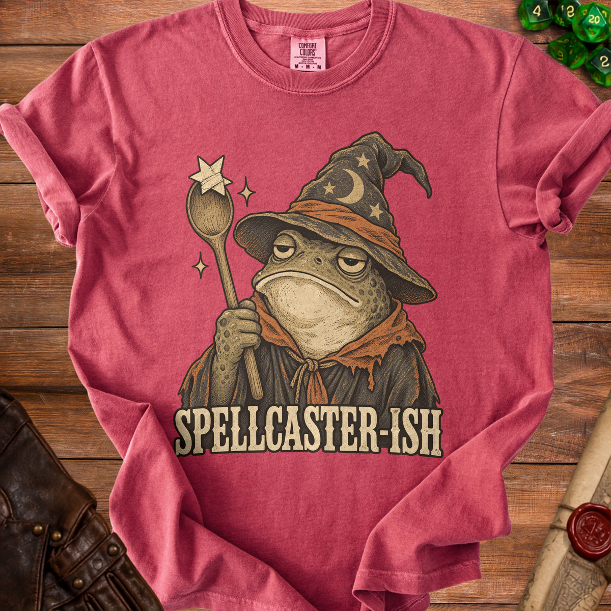Red t-shirt with a bored toad wearing a wizard hat and holding a spoon with a star.