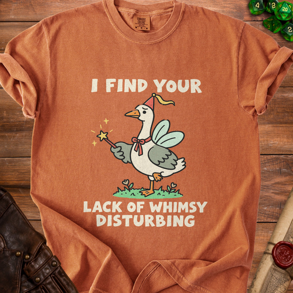 Orange t-shirt with goose wearing fairy wings holding a wand, text "I FIND YOUR LACK OF WHIMSY DISTURBING".