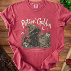 Pink t-shirt with "Potion Goblin" text and a black cat wearing a witch hat.