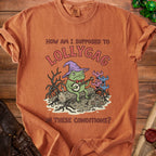 Orange t-shirt with a frog in a wizard hat playing banjo and text "How am I supposed to lollygag in these conditions?".