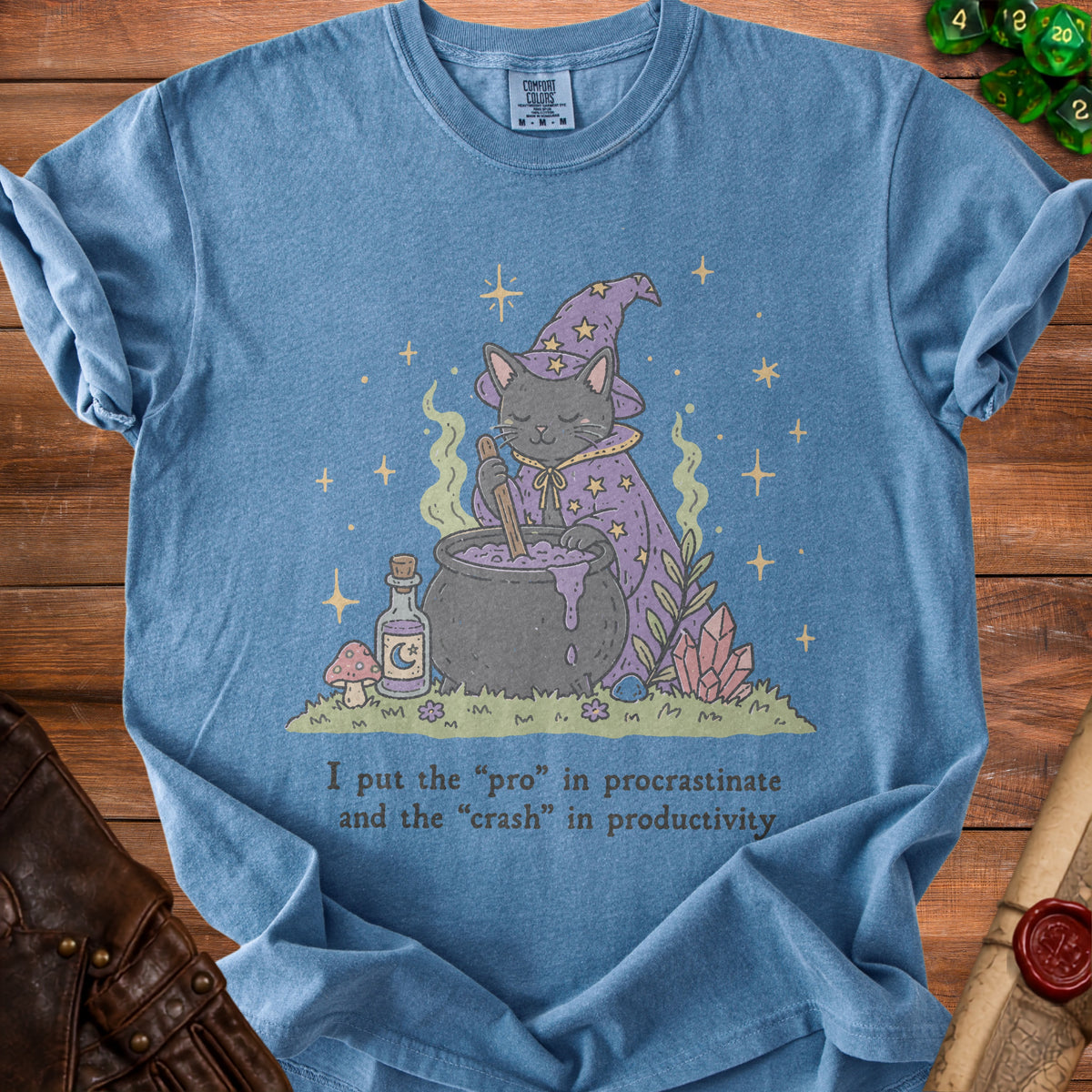 Blue t-shirt with a black cat in a witch hat brewing a potion.