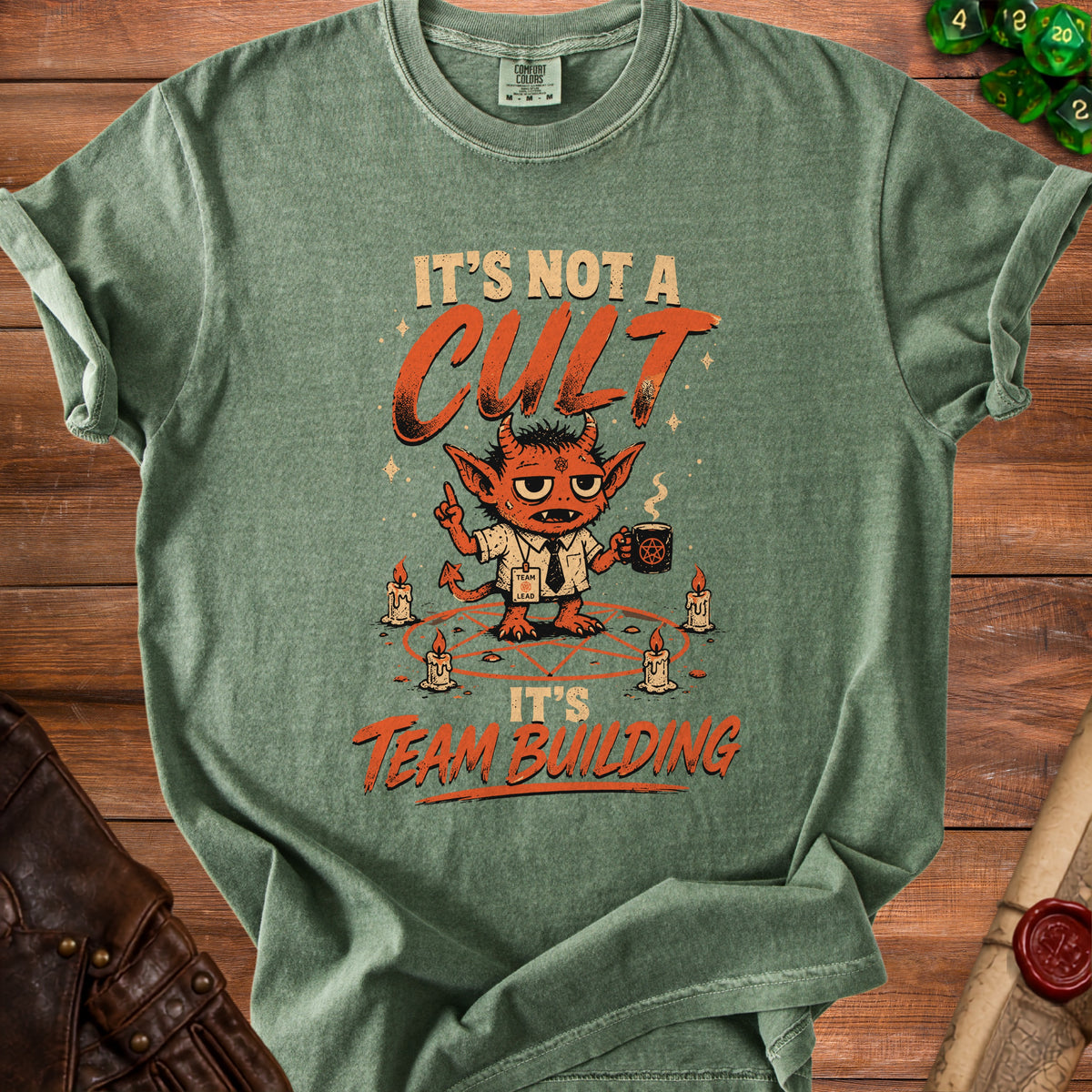Green t-shirt with devil graphic and "It's Not A Cult It's Team Building" text.