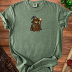 Green t-shirt with wizard bear holding a book titled "Main Character Energy (Later)".