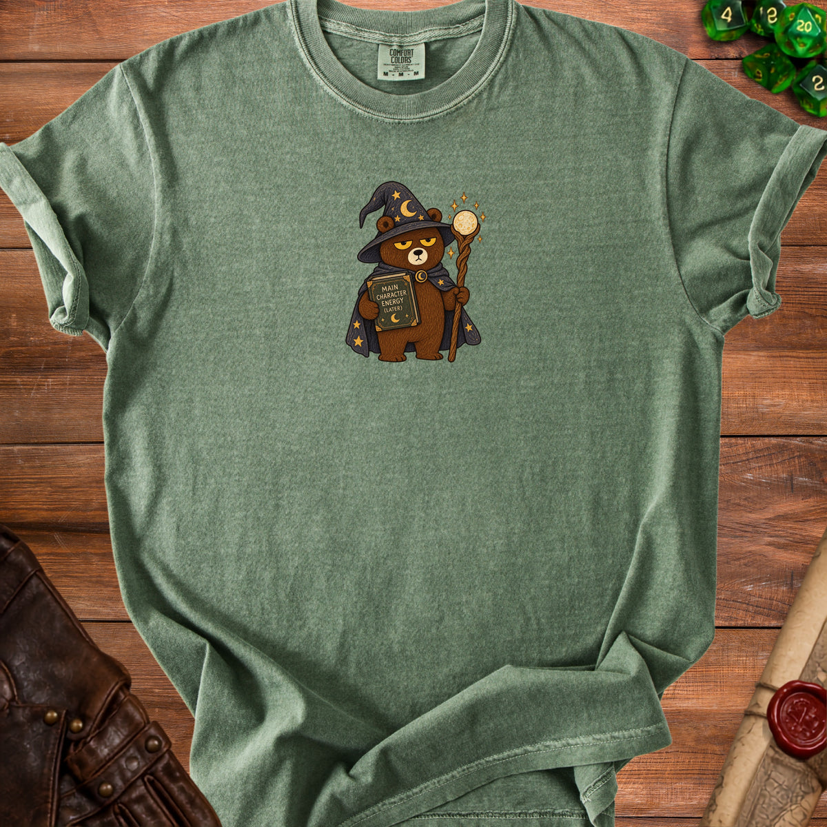 Green t-shirt with wizard bear holding a book titled "Main Character Energy (Later)".