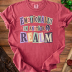 Red t-shirt with "Emotionally In Another Realm" text and celestial graphics.