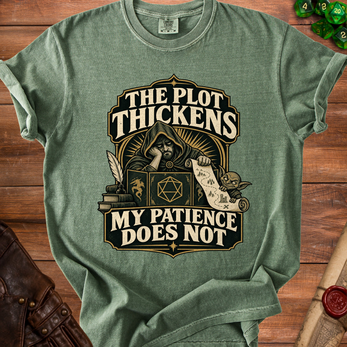 Green t-shirt with "The Plot Thickens, My Patience Does Not" text and fantasy art.