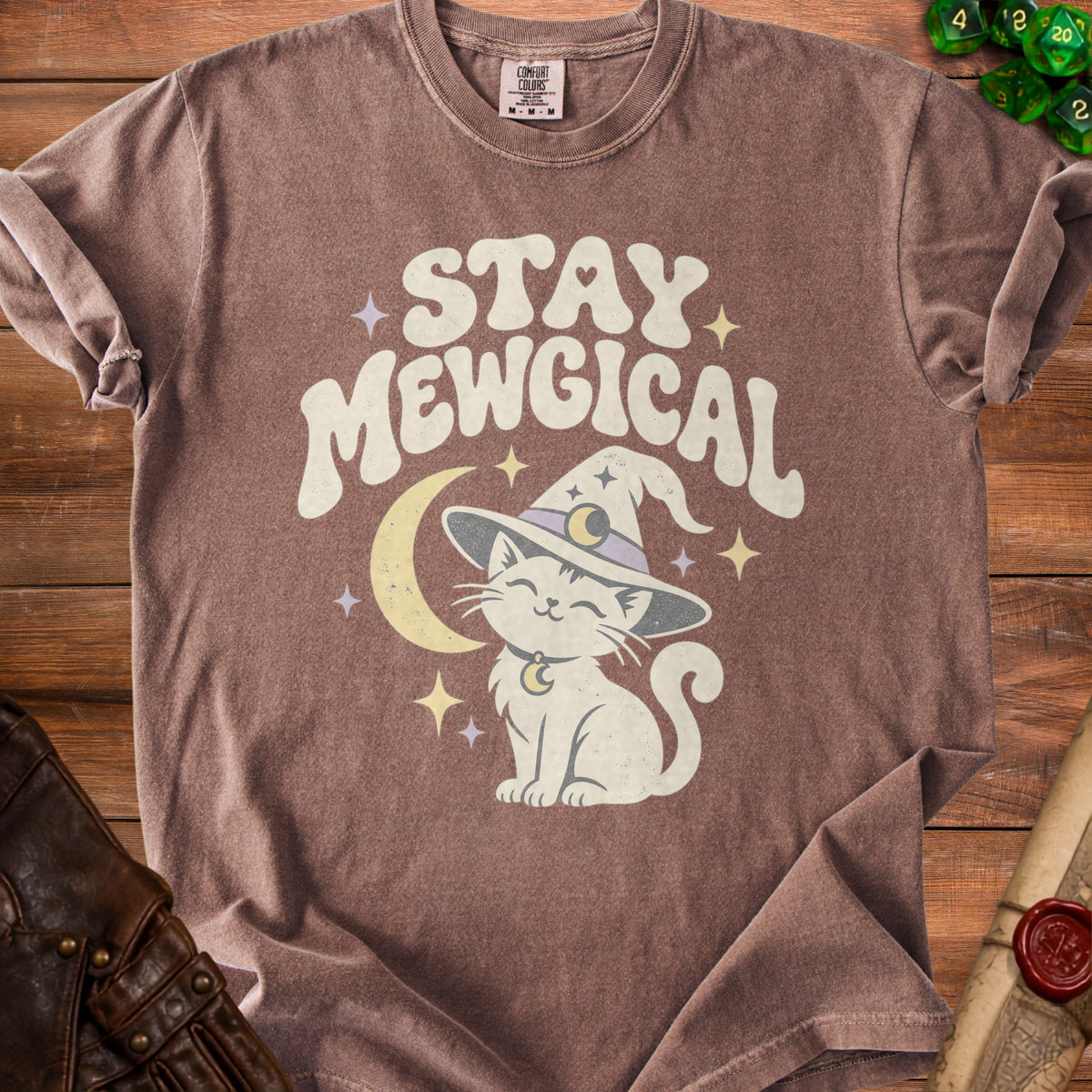 Brown t-shirt with a white cat wearing a witch hat and the text "STAY MEWGICAL".