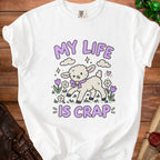 White t-shirt with a cartoon lamb and the text "MY LIFE IS CRAP".