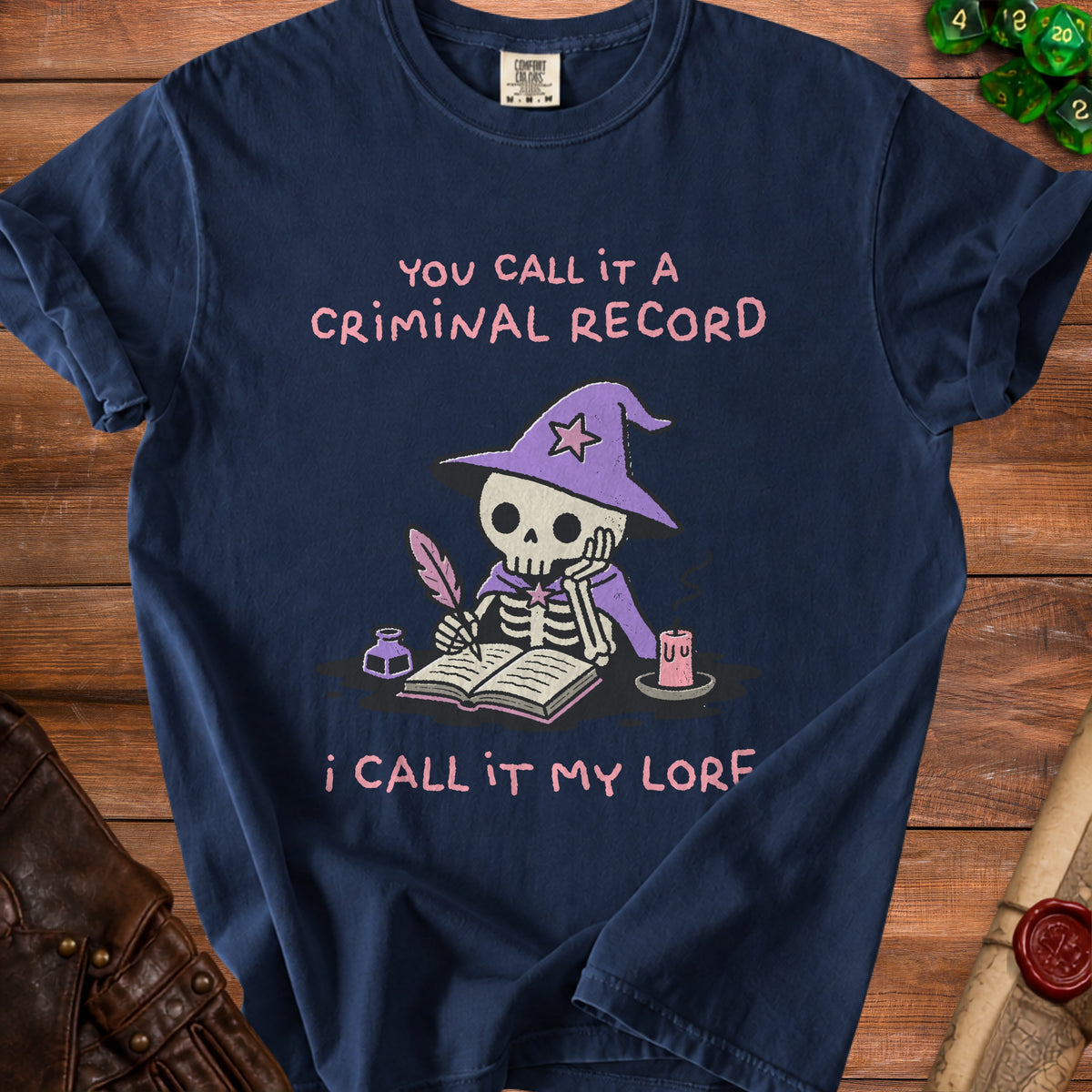 Dark blue t-shirt with a skeleton wizard writing lore, "You call it a criminal record, I call it my lore."