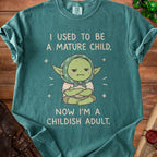Green t-shirt with "I used to be a mature child, now I'm a childish adult" text.