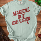 Light green Comfort Colors t-shirt with "Magical But Exhausted" text.
