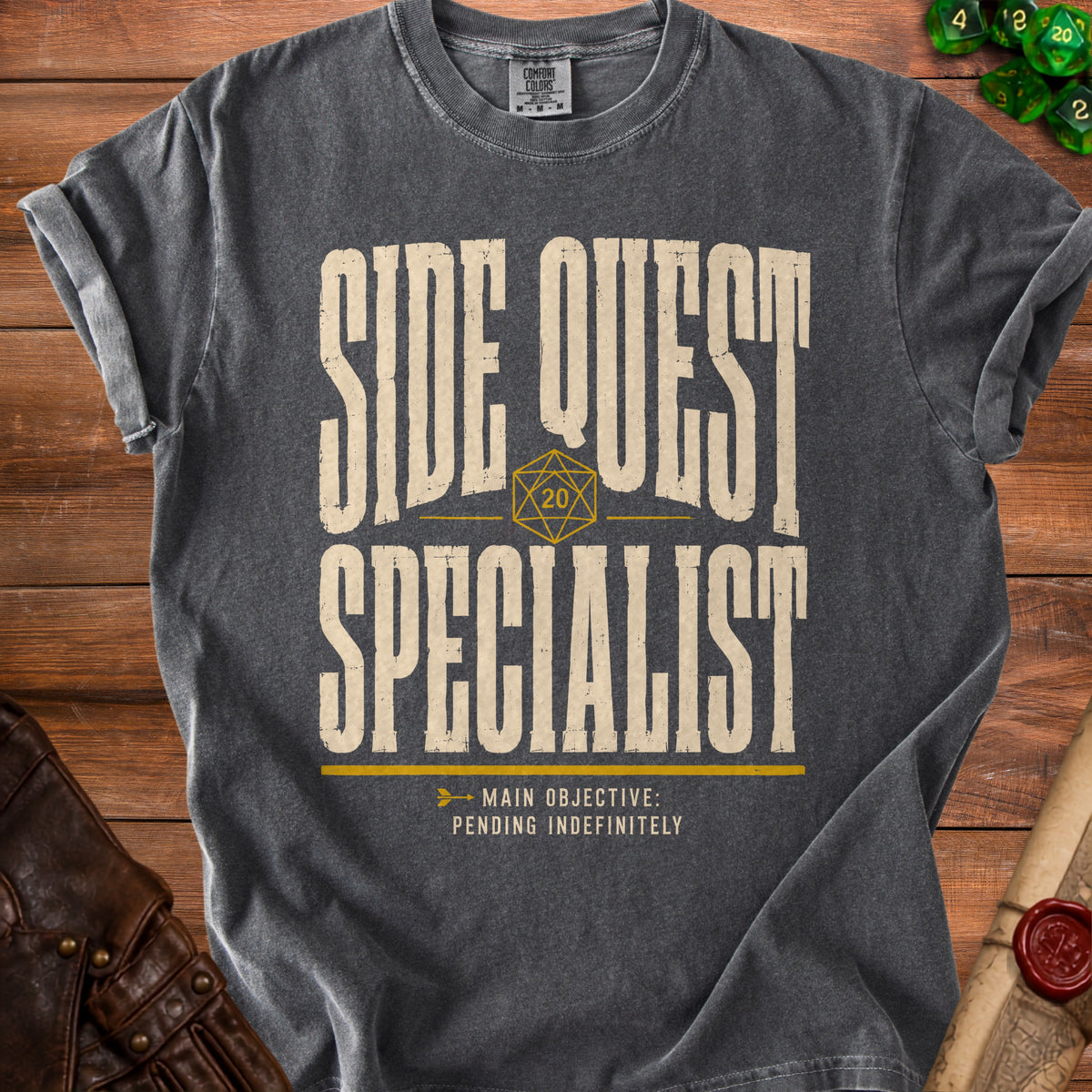 Dark gray t-shirt with "SIDE QUEST SPECIALIST" and "MAIN OBJECTIVE: PENDING INDEFINITELY".