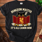 Black t-shirt with "Dungeon Master It's All Canon Now" and a black cat peering over a game screen.