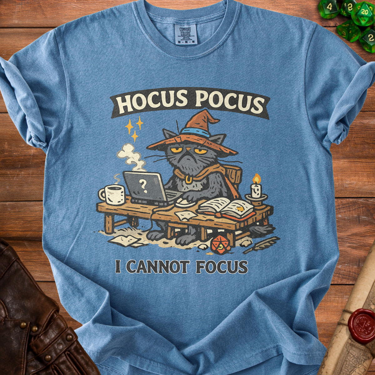 Blue t-shirt with a grumpy cat wearing a witch hat, sitting at a desk with "HOCUS POCUS" and "I CANNOT FOCUS."