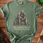 Green t-shirt with a knight sitting next to a sword, text reads "MY BONES HAVE OTHER PLANS".