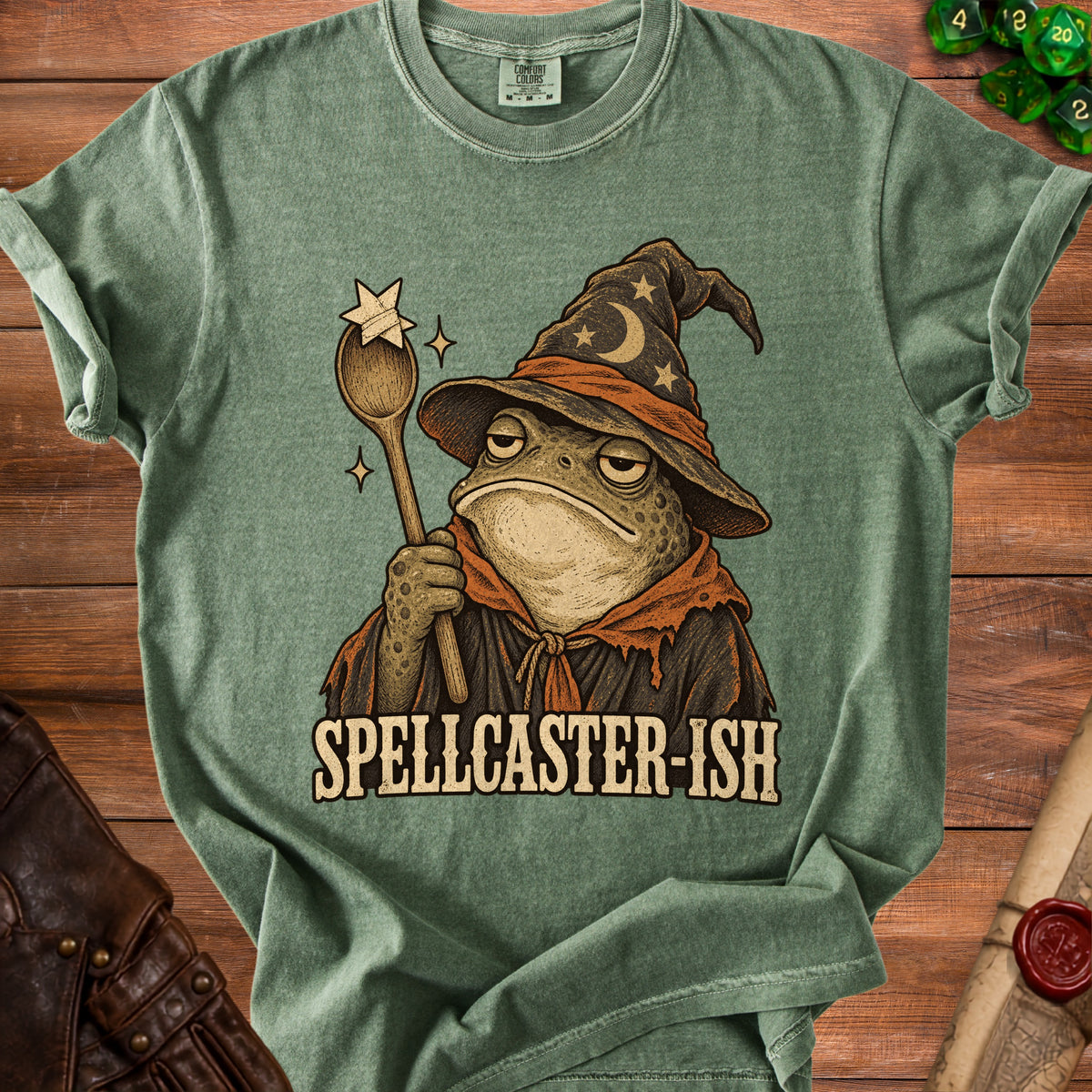 Green t-shirt with a frog wizard graphic that reads "SPELLCASTER-ISH".