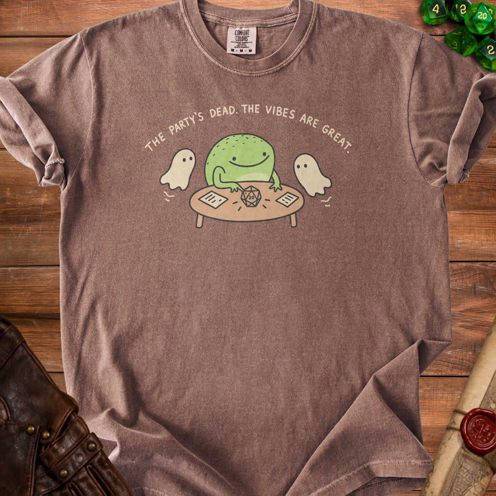 T-shirt with frog, ghosts, and dice graphic that reads "The party's dead. The vibes are great."