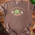 T-shirt with frog, ghosts, and dice graphic that reads "The party's dead. The vibes are great."