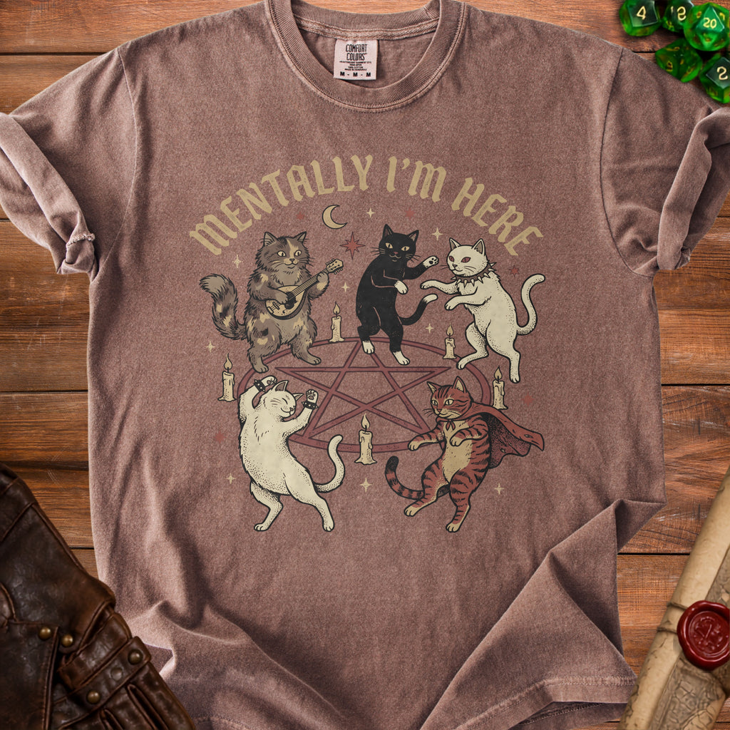 Brown t-shirt with cats dancing around a pentagram and the text "Mentally I'm Here".