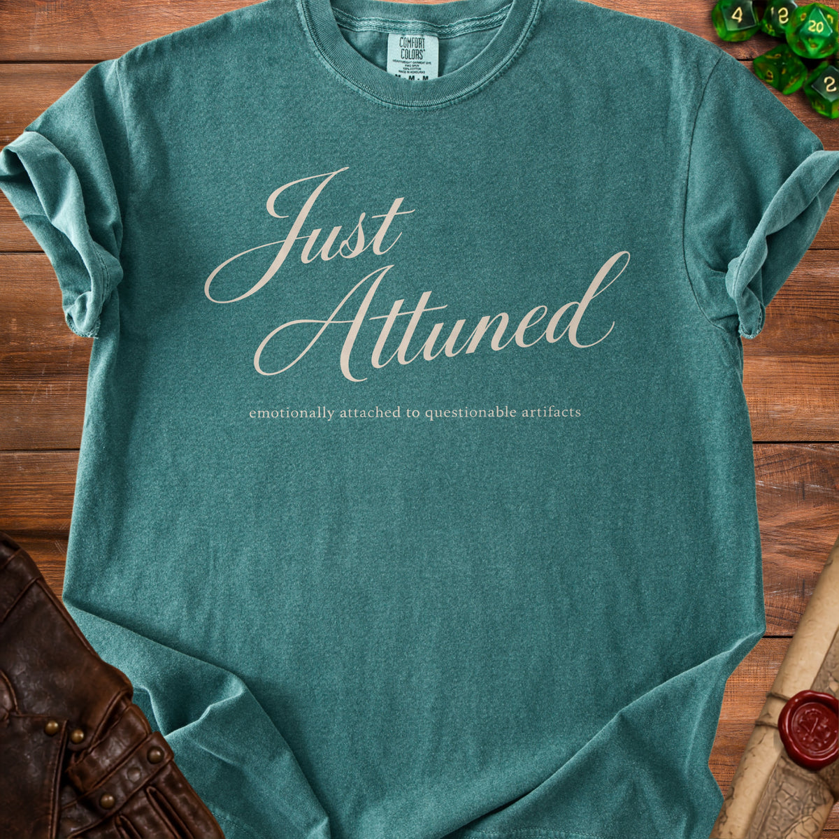 Teal t-shirt with "Just Attuned" and "emotionally attached to questionable artifacts" text.